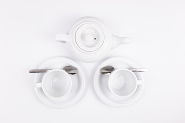 white porcelain teapot and cup on saucer for coffee or tea empty