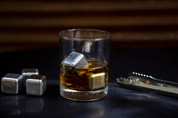 Glass of whiskey eith metal ice cubes
