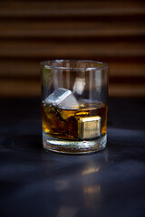 Glass of whiskey eith metal ice cubes