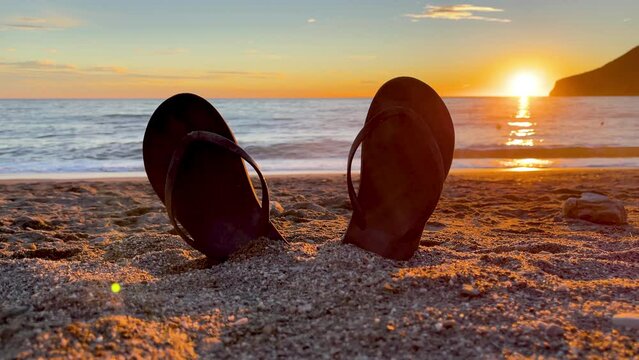 flip flop on the beach at sunset
