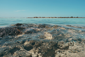Crystal clear sea water and underwater rocks at Elafonisi Beach, Crete. Low angle view. 