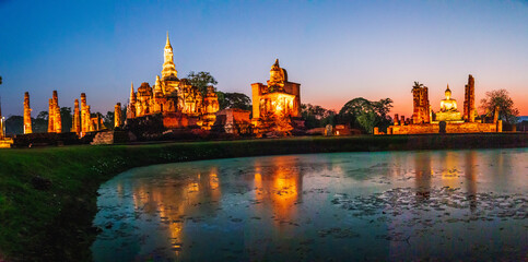 Fototapeta na wymiar Sunset at Wat Mahathat buddha and temple in Sukhothai Historical Park