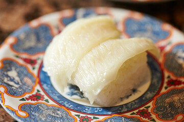 White fish sushi on a plate