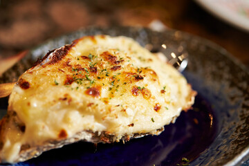 Grilled Butter Cheese Oysters on a Plate