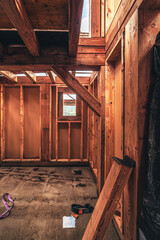 Inside a wooden house being built floor wet from rain