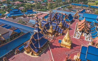 Fototapeta na wymiar Aerial view of Wat Phiphat Mongkhon blue temple in Sukhothai, Thailand