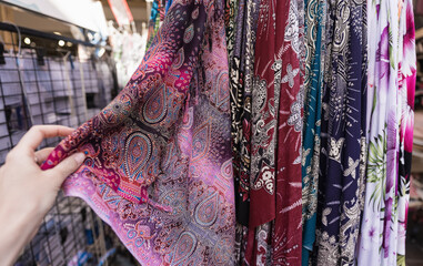 Woman choosing silk with middle east design scarf first person view, pov.