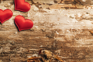 Conceptual photo of hearts on a rustic wooden background