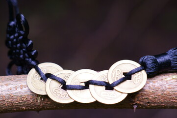 A bunch of Chinese coins in close-up. A symbol of prosperity and wealth. Blue shade.