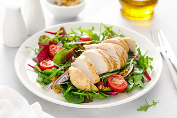 Chicken meat breast and fresh vegetable salad of tomato, onion and salad mix. Healthy and detox...