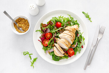 Chicken meat breast and fresh vegetable salad of tomato, onion and salad mix. Healthy and detox...