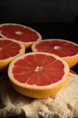 Obraz na płótnie Canvas sliced ripe grapefruit on a light cloth