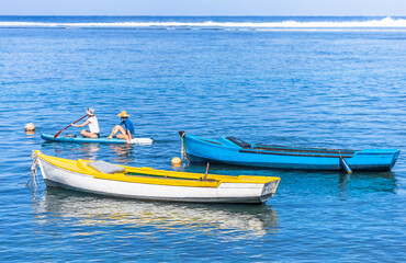 Naklejka na ściany i meble Barques de pêche et paddle assis au Bassin Pirogue, l’Etang-Salé, île de la Réunion 