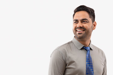 Portrait of a cheerful young businessman looking elsewhere