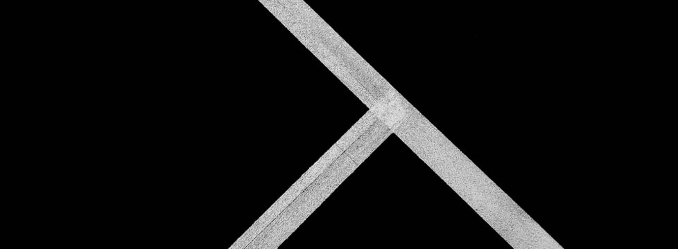 Lines, abstract sports background or texture on outdoor sports field. Black and white lines on the sports field (black and white shooting)