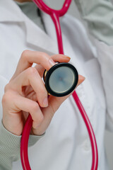 Medical stethoscope. Red medical stethoscope.A doctor with a stethoscope.A doctor holding a stethoscope