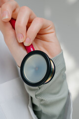 Medical stethoscope. Red medical stethoscope.A doctor with a stethoscope.A doctor holding a stethoscope