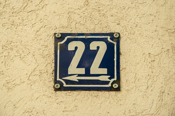 Weathered grunge square metal enamelled plate of number of street address with number 22