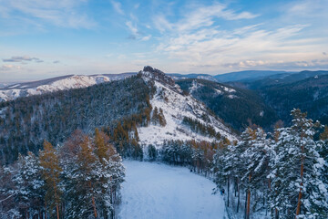 Aerial top view city Krasnoyarsk Russia taiga forest and rocks of stolby sanctuary, winter sunset - obrazy, fototapety, plakaty