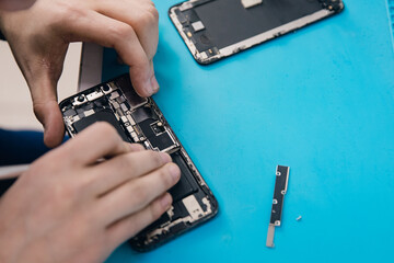 Concept repair modern mobile phone, master disassembles case to replace broken screen or...