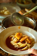 Traditional fish dish from Serbia food (serbian cuisine) and Hungarian cuisine - hot chili paprikaš fish soup with fresh catch of the day of Danube fish, red paprika and homemade pasta