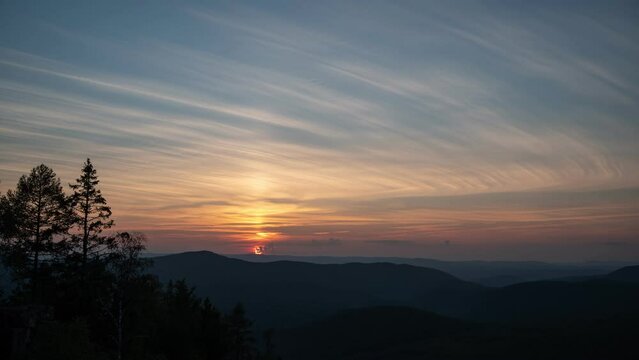 Beautiful sunset over Ural mountains. Sky with clouds time lapse