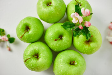 Flat lay Apple flowers and ripe green apples on a white background, Fruits and flowers, sping concept. Top view