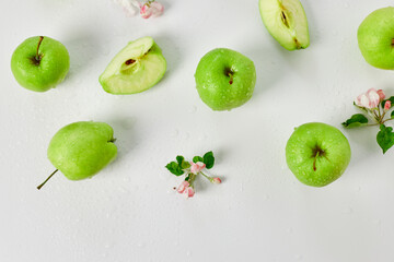 Flat lay Apple flowers and ripe green apples on a white background, Fruits and flowers, sping concept. Top view