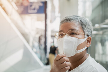 Senior Asian eyeglasses in New normal life wear medical facemask protection virus corona pandemic...