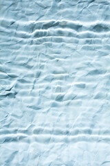 Abstract blue blurry paper background with parallel lines. Minimalist background in blue.