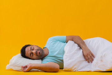 Portrait of a young man sleeping covered with a blanket