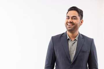 Portrait of a cheerful young businessman in formal outfit looking elsewhere