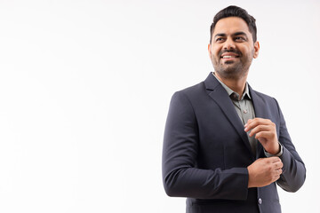 Portrait of a cheerful young businessman in formal outfit looking elsewhere