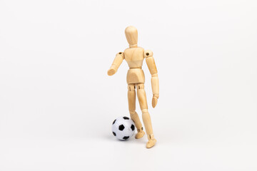 Wooden mannequin with soccer ball isolated on white background. Football player concept.
