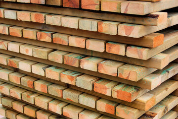 Naklejka premium Stacks of wooden planks and boards. Timber and lumber, woodworking background