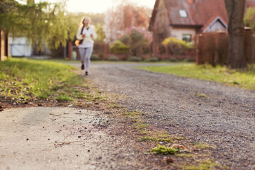 Fototapeta na wymiar Running woman outdoors at sunlight