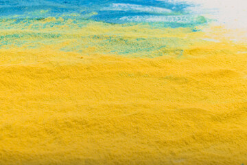 Ukrainian flag colours. The concept of war in Ukraine. Blue and yellow background from holi powder paint.