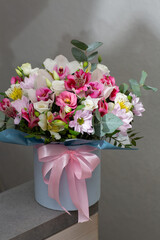 Beautiful bouquet of flowers in round box on a white table. Gift for holiday, birthday, Wedding, Mother's Day, Valentine's day, Women's Day.