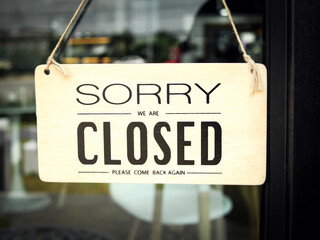 closed sign affixed to the bank's glass door. concept of service business closed in holiday