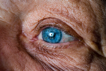 Close up, macro photo of a senior female blue color eyes, iris, pupil, eye lashes, eye lids.