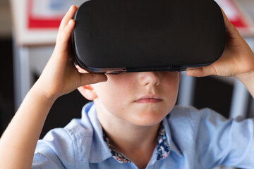 Close-up of african american elementary schoolboy wearing vr glasses in classroom