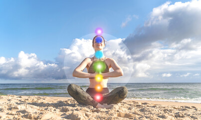 Seven chakras and aura. Slim woman meditating in lotus position in nature. Concept of spiritual health and self healing - obrazy, fototapety, plakaty