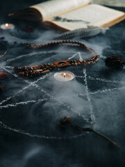 Black magic painted pentagram in smoke , ancient amulets