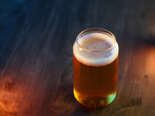 glass of light cold beer on a wooden table copy space