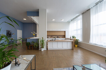 minimalist modern interior design huge bright apartment with an open plan in Scandinavian style in white, blue and dark blue colors with columns in the center. includes kitchen area, office and lounge