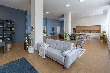 minimalist modern interior design huge bright apartment with an open plan in Scandinavian style in white, blue and dark blue colors with columns in the center. includes kitchen area, office and lounge