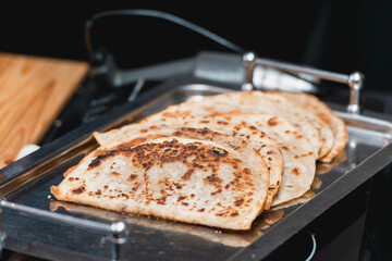 Cheburek traditional balkan meat pastry pie with herbs on a metal plate