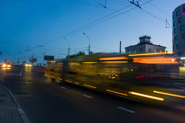Blurred bus movement along the overpass in the evening.