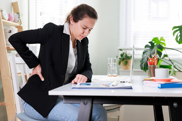 Young busines woman suffering with back pain