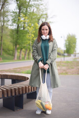 Fototapeta premium a young modern girl holding an eco bag with products